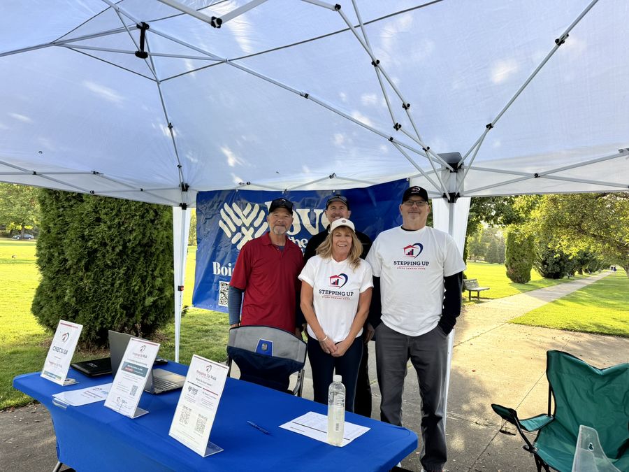 Volunteers at the check-in table under the Boise Love INC banner