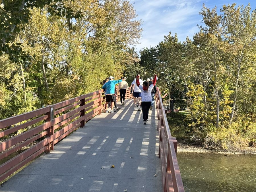 Walkers crossing a footbridge over the Boise River